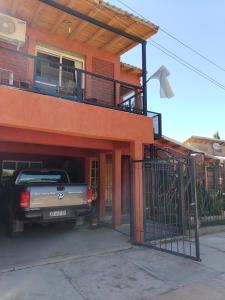 a truck parked outside of a house with a balcony at Departamento Uspallata in Uspallata