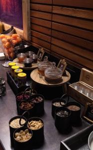 a buffet line with bowls of food and other foods at "Quality Hosts Arlberg" Hotel Lux Alpinae in Sankt Anton am Arlberg