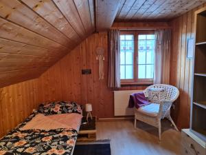 a bedroom with a bed and a chair in a room at Chalet Ferreira in Weite