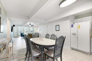 a kitchen and dining room with a table and chairs at 118 E ARCTIC UNIT B SALTY SHACK ACROSS THE ST FROM BEACH in Folly Beach