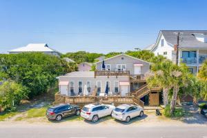a house with three cars parked in front of it at 118 E ARCTIC UNIT B SALTY SHACK ACROSS THE ST FROM BEACH in Folly Beach