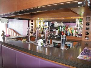 a bar with a counter with a lot of alcohol at The Arthington in Blackpool