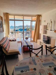 een woonkamer met uitzicht op een balkon bij Apartamento Palmeras in La Pineda