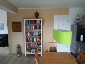 a living room with a book shelf filled with books at Haus Fernblick in Breitungen