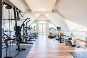 a gym with treadmills and elliptical machines at Hotel Markgraf in Lehnin