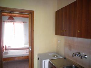 a small kitchen with a sink and a window at Kostas Studios in Vasiliki