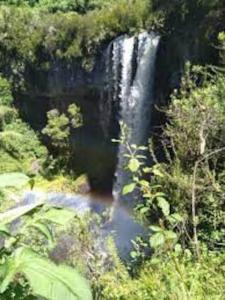a waterfall in the middle of a river at Maverick Camp, Rondavels and Homestay in Nyandarua 