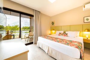 a hotel room with two beds and a balcony at Reserva dos Lagos in Laranjeiras +24 photos