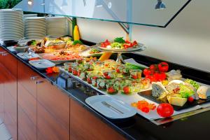 
a kitchen counter filled with lots of different types of food at Best Western Premier IB Hotel Friedberger Warte in Frankfurt/Main
