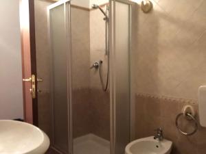 a bathroom with a shower with a sink and a toilet at Villa Natale in Sestola +24 photos