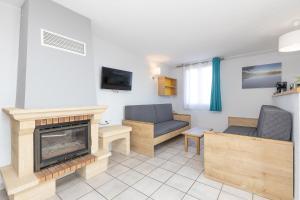 a living room with a fireplace and a couch at Hébergements du Lac de Madine in Heudicourt-sous-les-Côtes