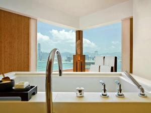 a bathroom with a sink and a bath tub at The Upper House in Hong Kong