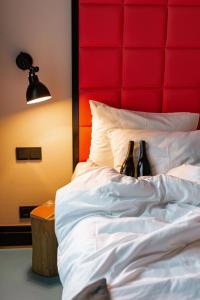 
a bed with a white comforter and pillows at Hotel Rum Budapest in Budapest
