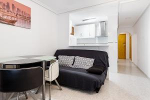 a living room with a couch and a table at Studio Playa del Cura in Torrevieja