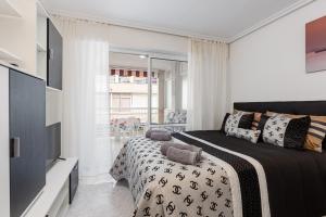 a bedroom with a bed and a television in it at Studio Playa del Cura in Torrevieja