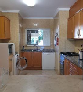 a kitchen with a sink and a dishwasher at Alvor Vila da Praia in Alvor
