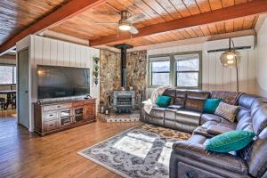 a living room with a leather couch and a fireplace at Prescott Home with Deck and Grill Close to Hiking! in Prescott