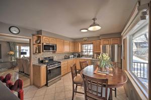 a kitchen with a wooden table and a dining room at Pet-Friendly Retreat about 1 Mi to St Louis River! in Superior