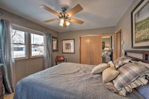 a bedroom with a bed with a ceiling fan at Pet-Friendly Retreat about 1 Mi to St Louis River! in Superior