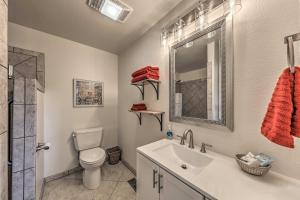 a bathroom with a sink and a toilet and a mirror at Ruidoso House with Beautiful Indoor and Outdoor Space! in Ruidoso +21 photos