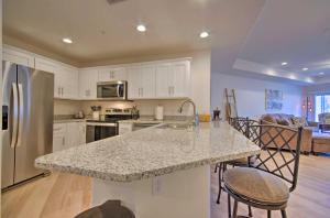 a kitchen with a granite counter top and appliances at Lakefront Escape with Water Views and Pool Access in Lake Ozark