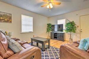 a living room with two couches and a table at Stunning Gulfport Getaway about 1 Mi to the Beach in Gulfport