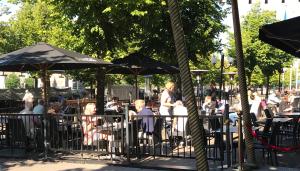 a group of people sitting at tables with umbrellas at Best Western Motala Stadshotell in Motala