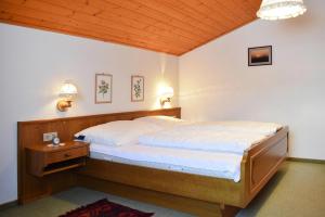 a bedroom with two beds and a wooden ceiling at Ferienhaus Niedernsill in Niedernsill
