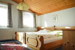 a bedroom with a wooden bed with a wooden ceiling at Ferienhaus Niedernsill in Niedernsill