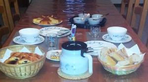 einen Tisch mit Teller mit Speisen und Brotschalen in der Unterkunft Le Domaine des Gemmes 