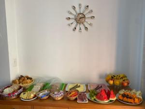 a table topped with lots of different types of food at Pousada Habitue in Gramado