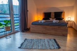 a bedroom with a bed and a large window at Źródło Energii in Małastów