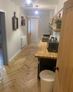 a kitchen with a counter and a wooden floor at 1-Bed Apartment in Wells in Wells