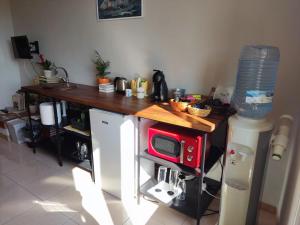a kitchen with a counter with a red microwave at Casa Castellano in Nola +29 photos