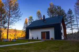 uma casa numa colina com um telhado preto em Źródło Energii em Małastów