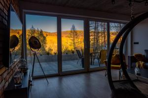 a living room with a large glass door with a view at Źródło Energii in Małastów