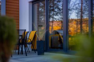 a patio with a table and chairs and a window at Źródło Energii in Małastów