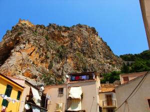 a mountain behind some buildings in front of a building at Casa Barranco in Cefalù