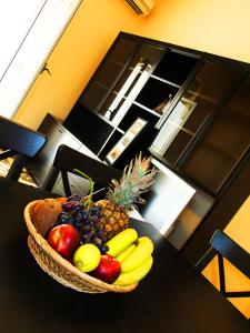 a basket of fruit sitting on a table at Casa Barranco in Cefalù +24 photos