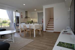 a kitchen and dining room with a table and chairs at Casa das Feiteiras by AnaLodges in Ponta Delgada
