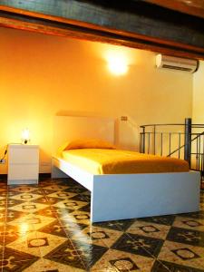a bedroom with a bed in a room at Casa Barranco in Cefalù