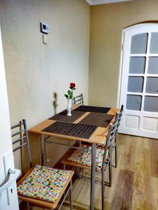 a table and chairs in a room with a window at Király Apartman in Gheorgheni
