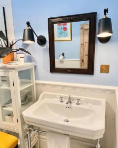 a bathroom with a white sink and a mirror at Old Riga Designer Luxury Apartment in Riga +32 photos