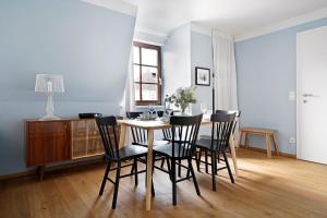a dining room table and chairs in a room at numa I Flute Apartments in Salzburg