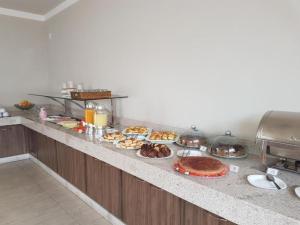 a buffet line with many different types of food at Habitat Prime Hotel in Leme