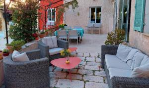 a patio with couches and tables and a table and chairs at Villa Mia in Vence