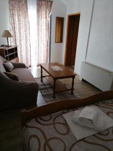 a living room with a couch and a coffee table at Apartment 3a, first floor in Rogoznica