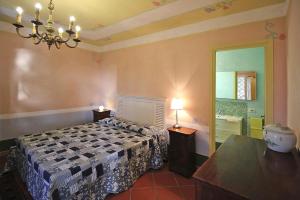 a bedroom with a bed and a table and a mirror at Holiday home, Monteggiori in Santa Lucia