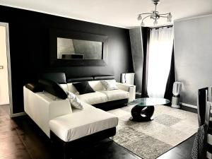 a living room with a couch and a table at Appartement near Disney Parks in Chessy