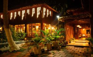 a building with plants in front of it at night at Coral Reef Resort & Spa, Havelock in Havelock Island